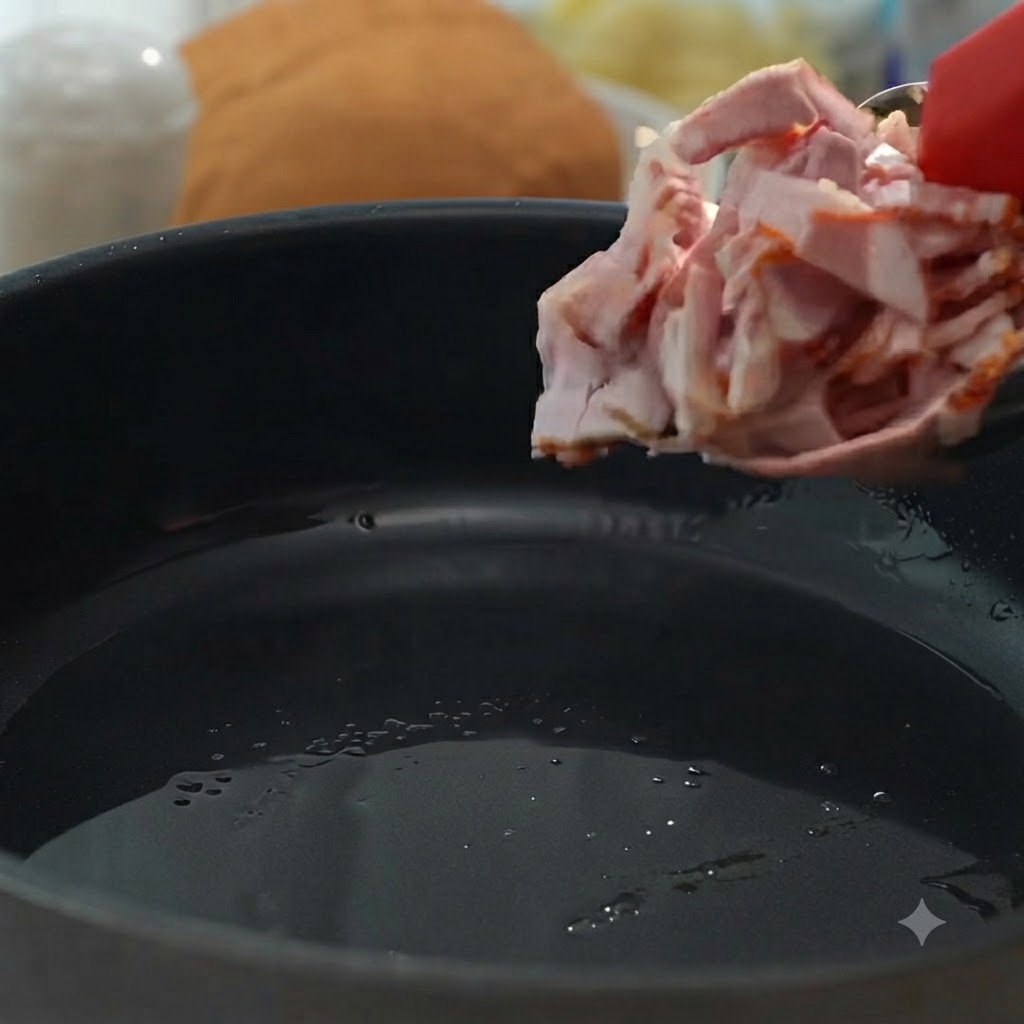 Bacon pieces being added to a pan to be fried until crisp and browned.