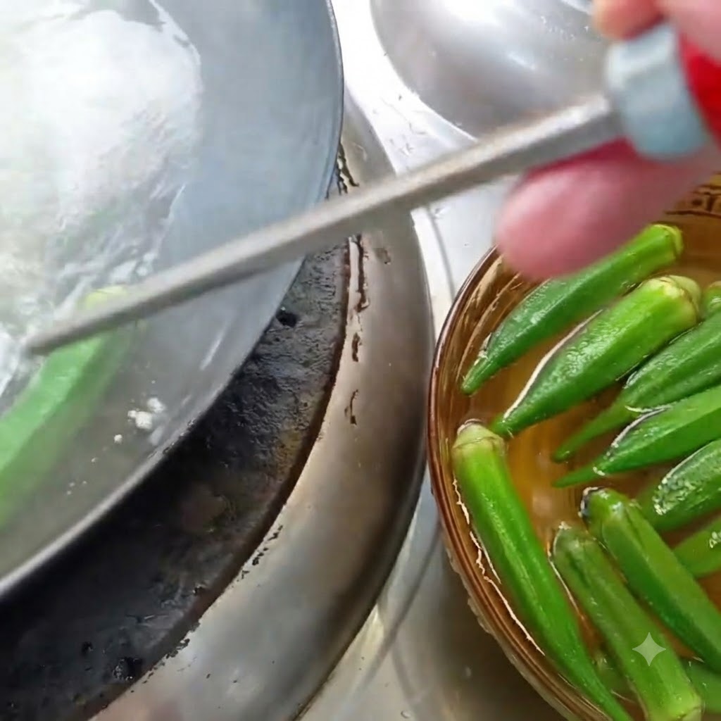 Okra being blanched in a pot of boiling water next to a bowl of soaked okra.