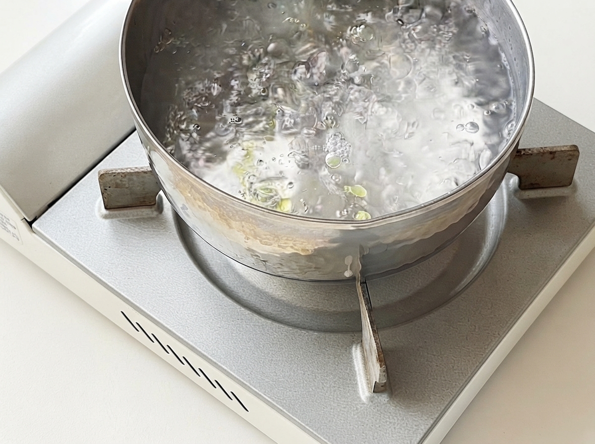 Spaghetti cooking in a pot of boiling water.