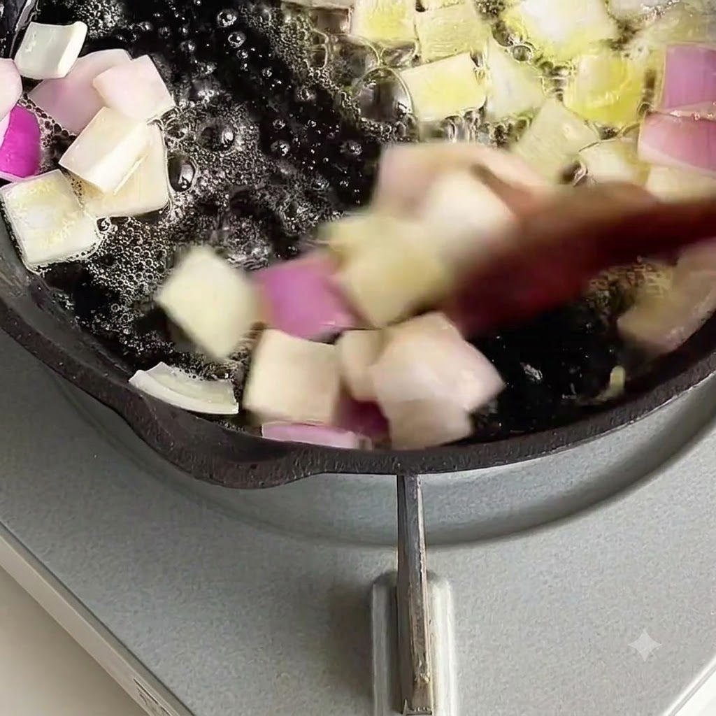 Diced onions being stir-fried in melted butter.
