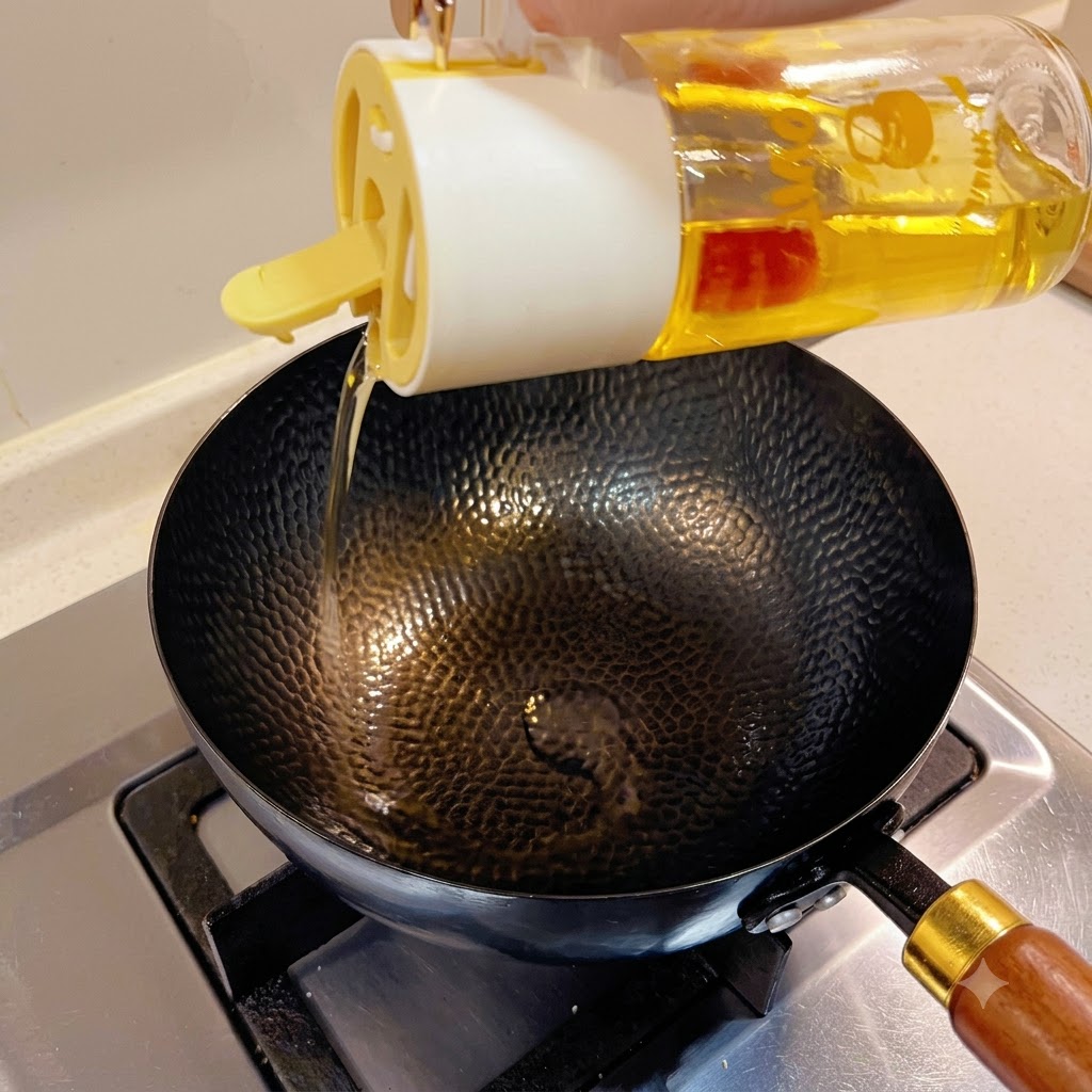 Cooking oil being poured from a glass dispenser into a black hammered wok on a stovetop.