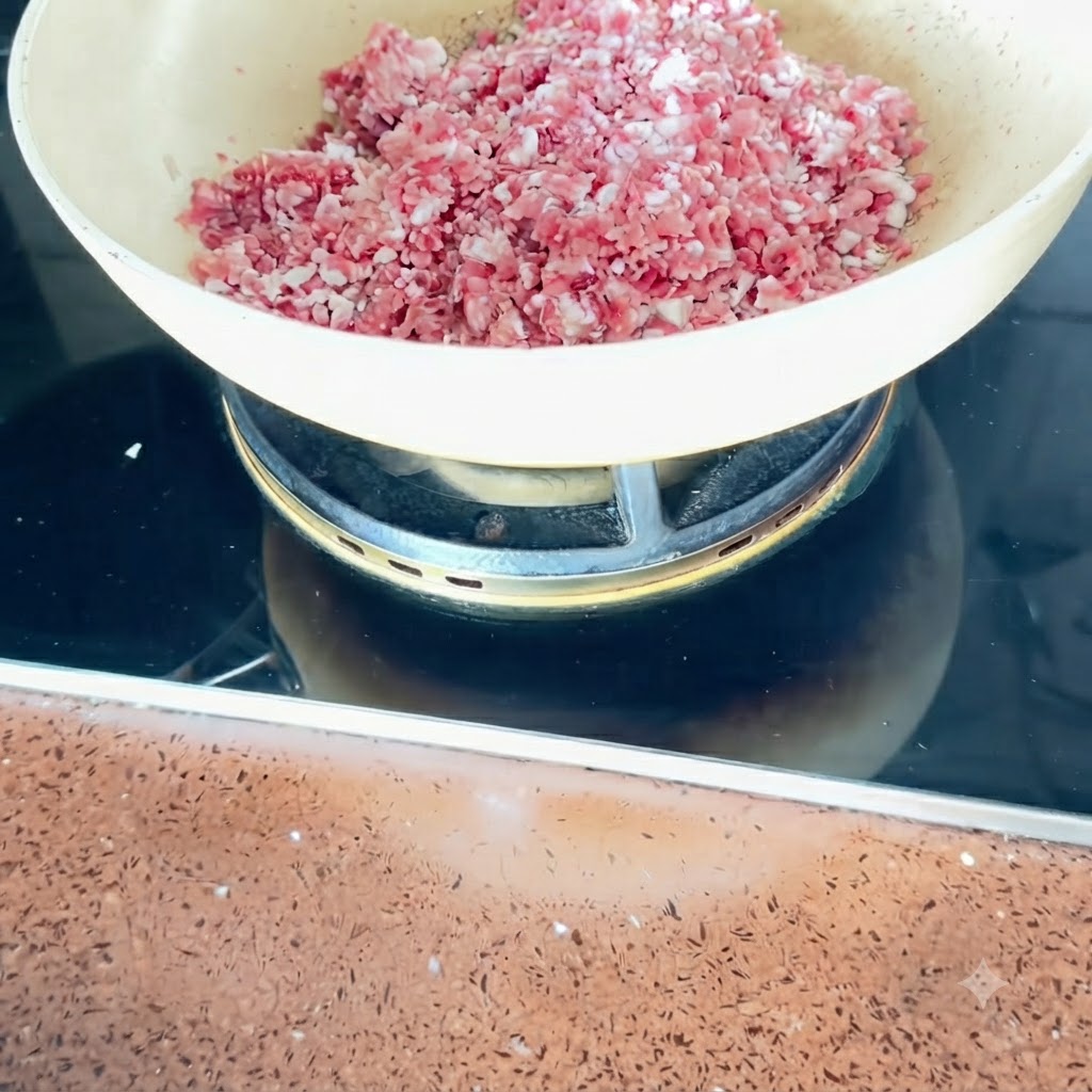 Pork belly cubes being stir-fried in a pan over medium heat.