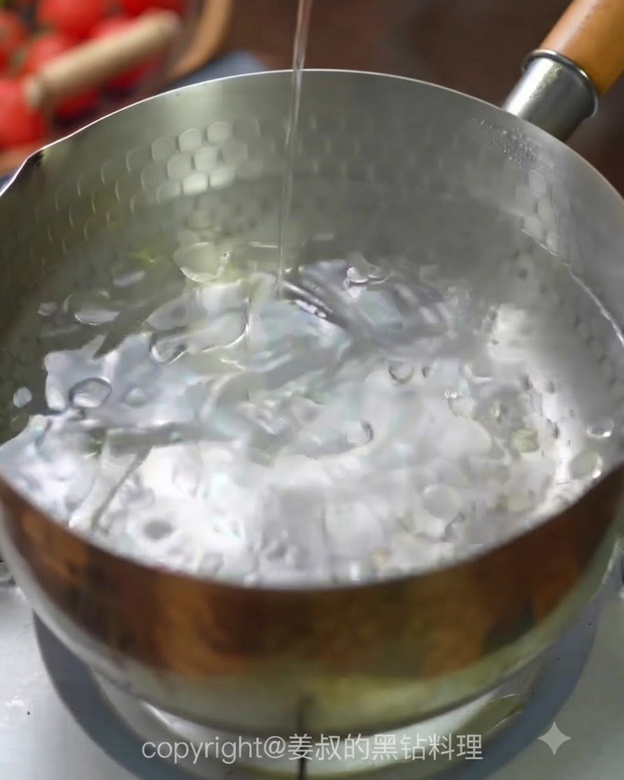 Spaghetti noodles being dropped into a pot of boiling water.