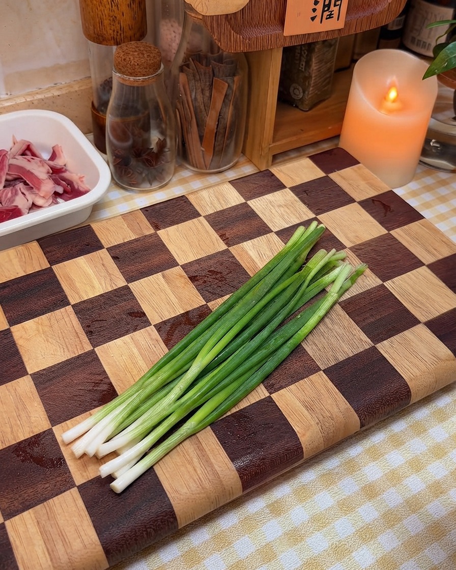 Fresh green onions arranged and ready for chopping on a wooden board.