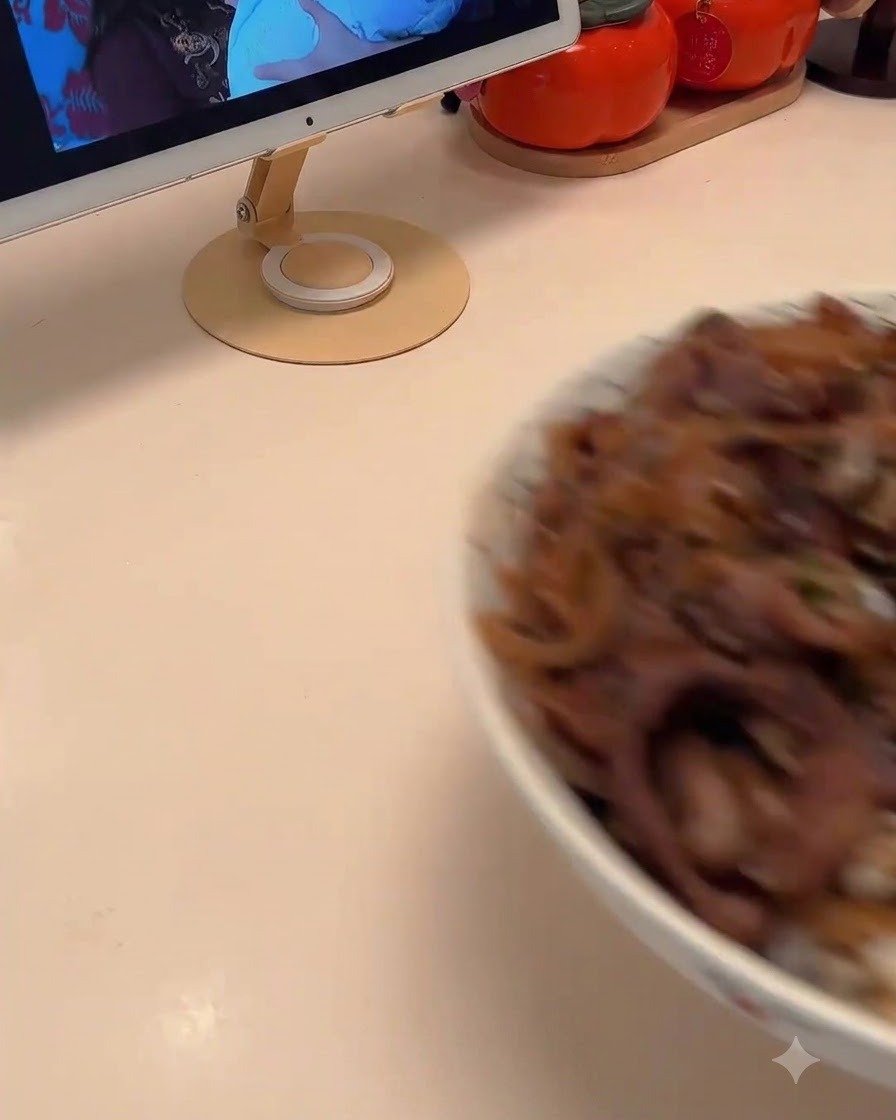 Sliced onions being stir-fried in a pan with a melting piece of butter.