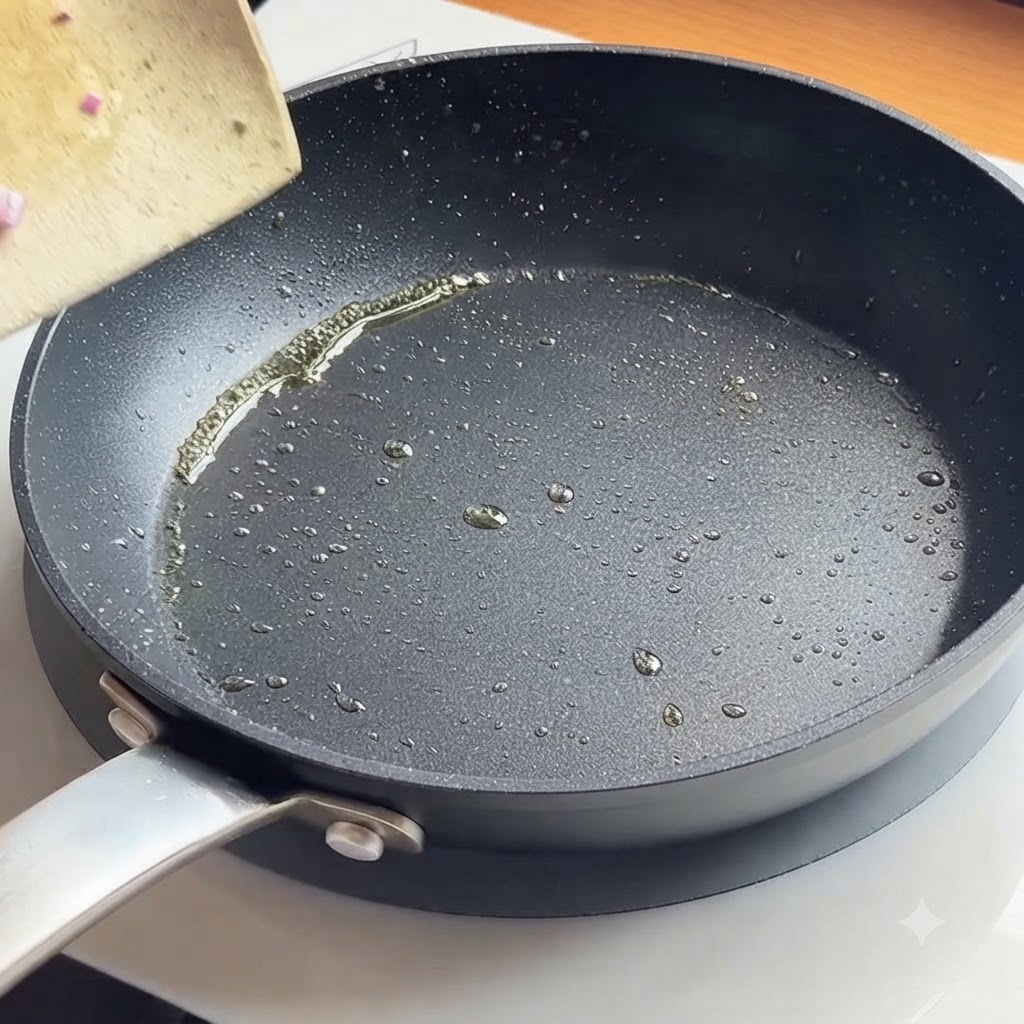 Chopped red onions sizzling in a hot pan with oil.
