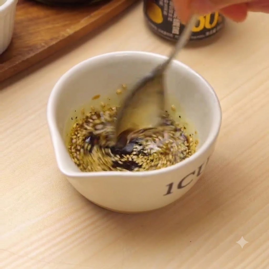 A spoon actively whisking the dressing ingredients inside a small white bowl.