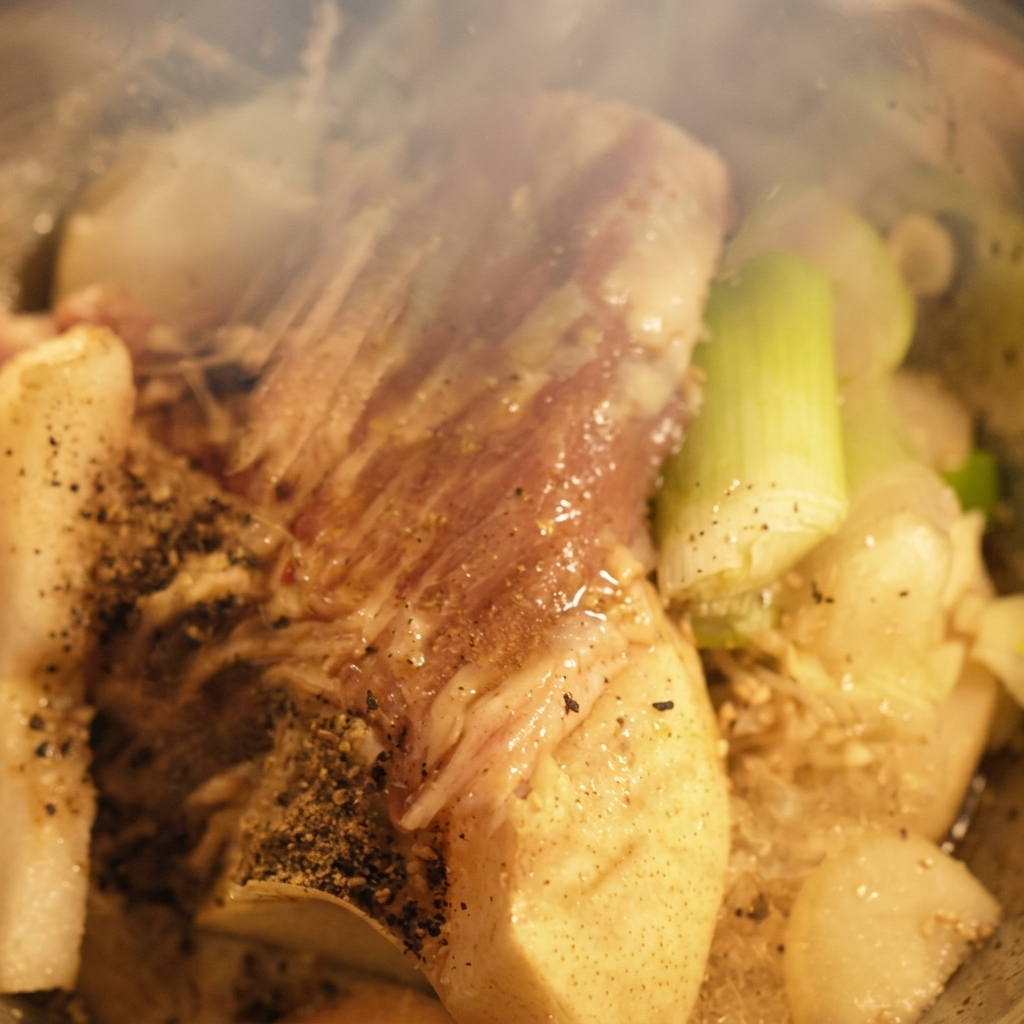 Liquid seasonings being poured over the ingredients inside the blender.