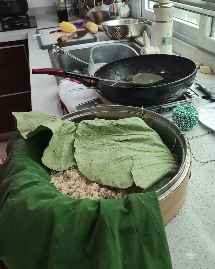 A wrapped lotus leaf package sitting in a steamer basket with green and white cooking twine nearby.
