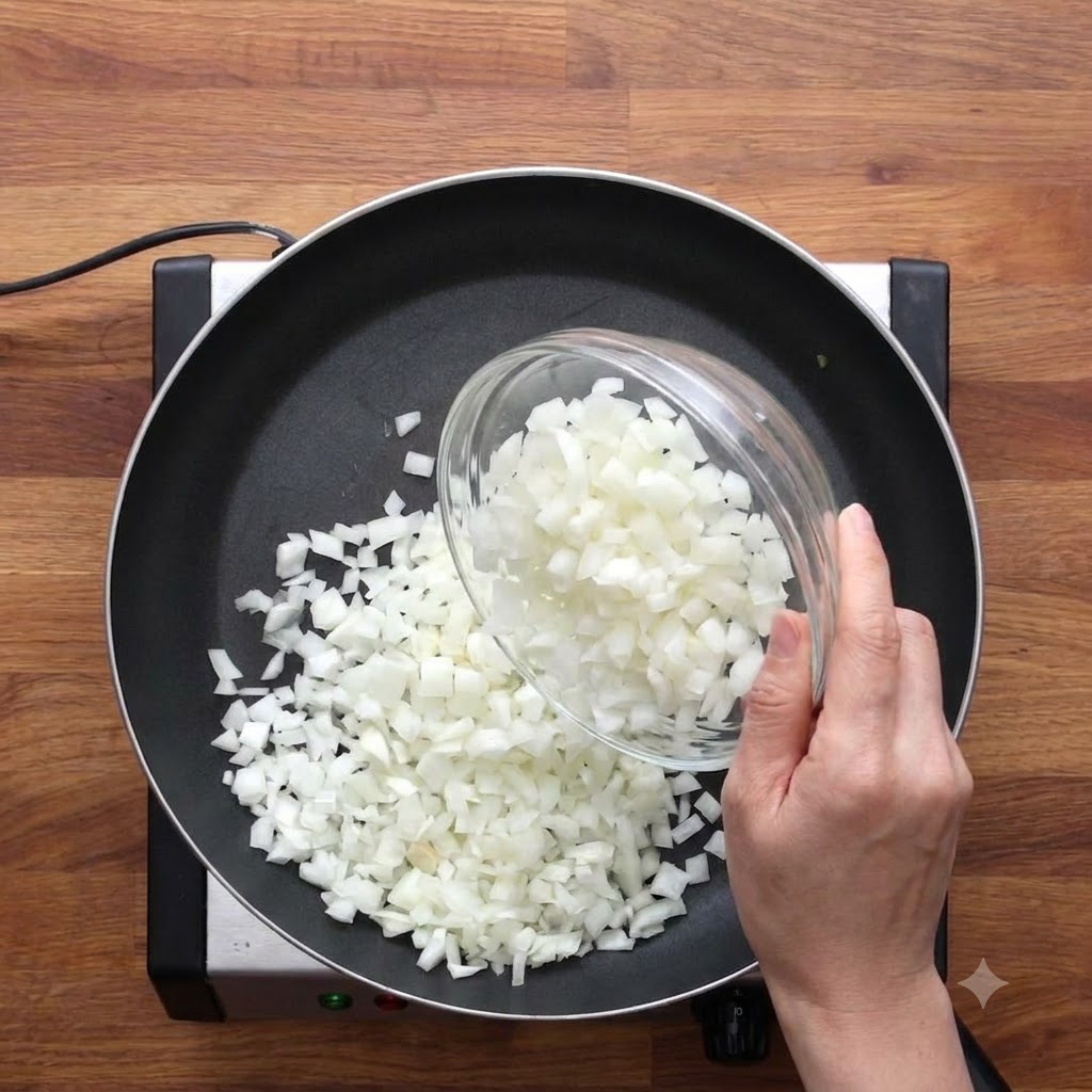 Salt being sprinkled over chopped onions in a frying pan.