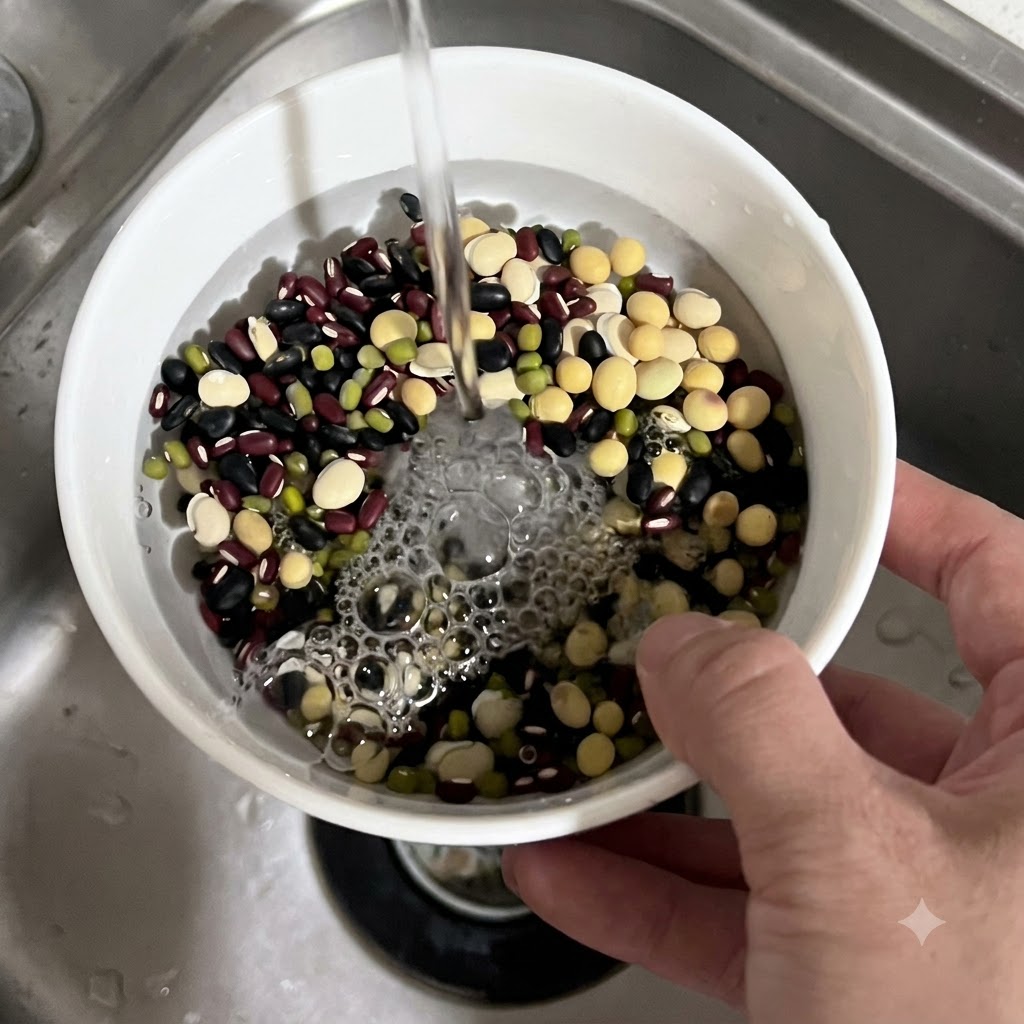 Water running from a faucet into a white bowl filled with a mix of multi-colored beans.