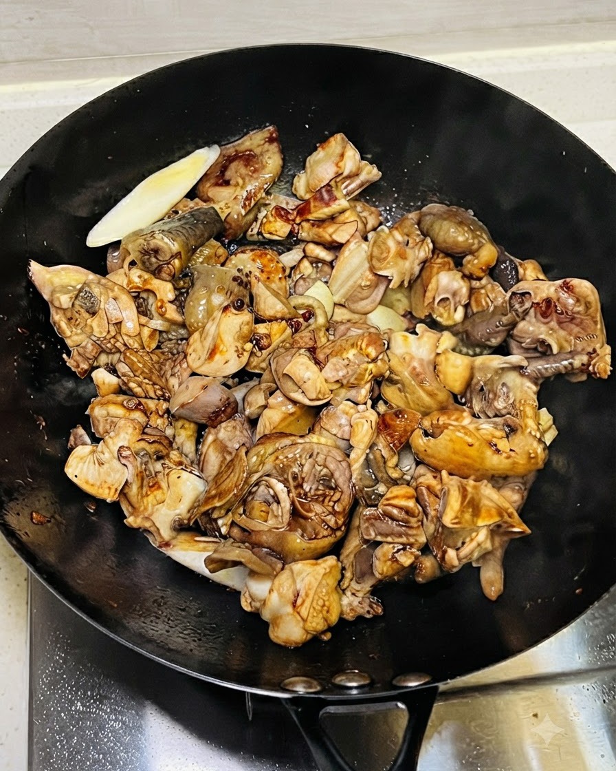 Pouring sauces including light soy sauce and dark soy sauce over the chicken.