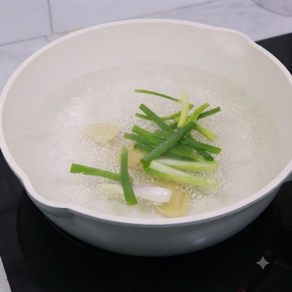 Ginger slices and scallions boiling in a pot of water with cooking wine.