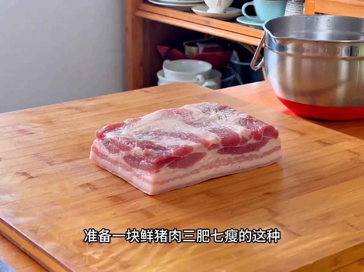 Fresh pork cut placed on a cutting board, ready for prep work.