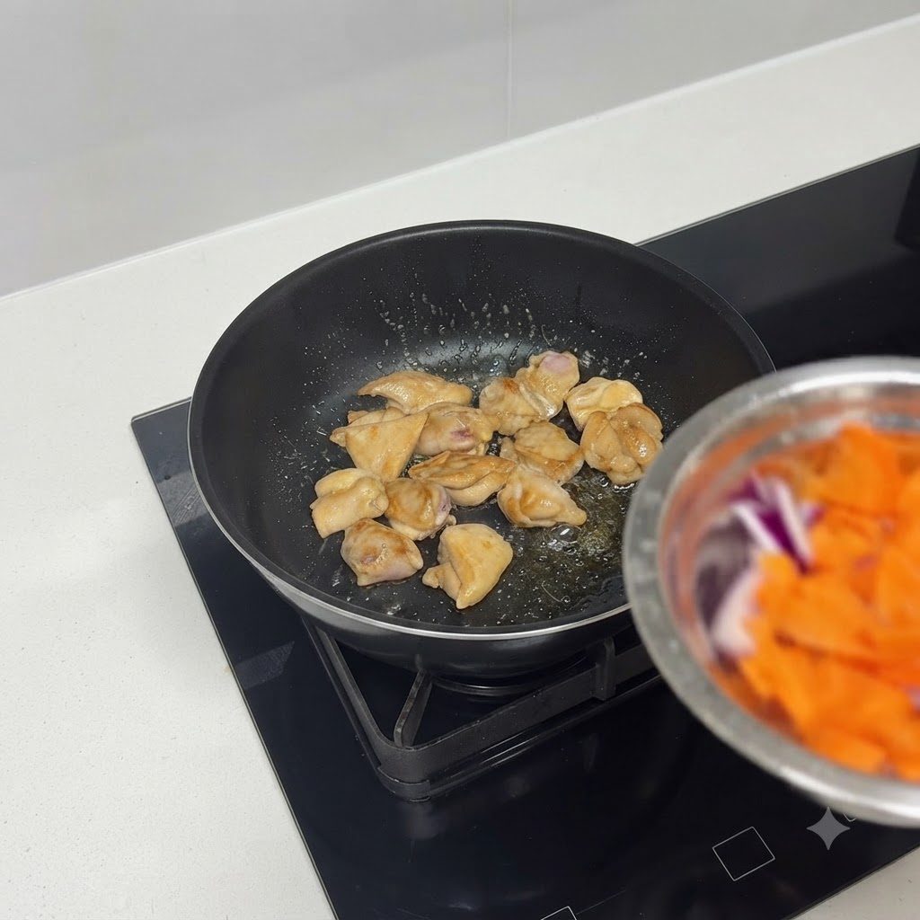 Chicken pieces browning nicely in a skillet.