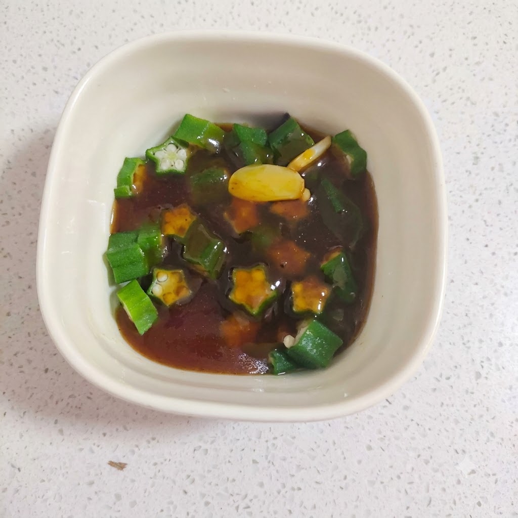 Okra boiling in a pot of hot water.