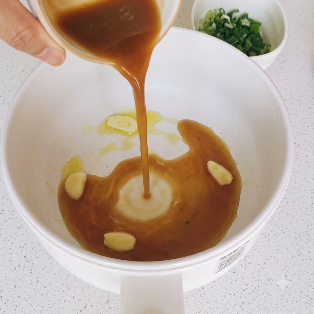 Brown sauce mixture being poured into a pan with sautéed garlic slices.