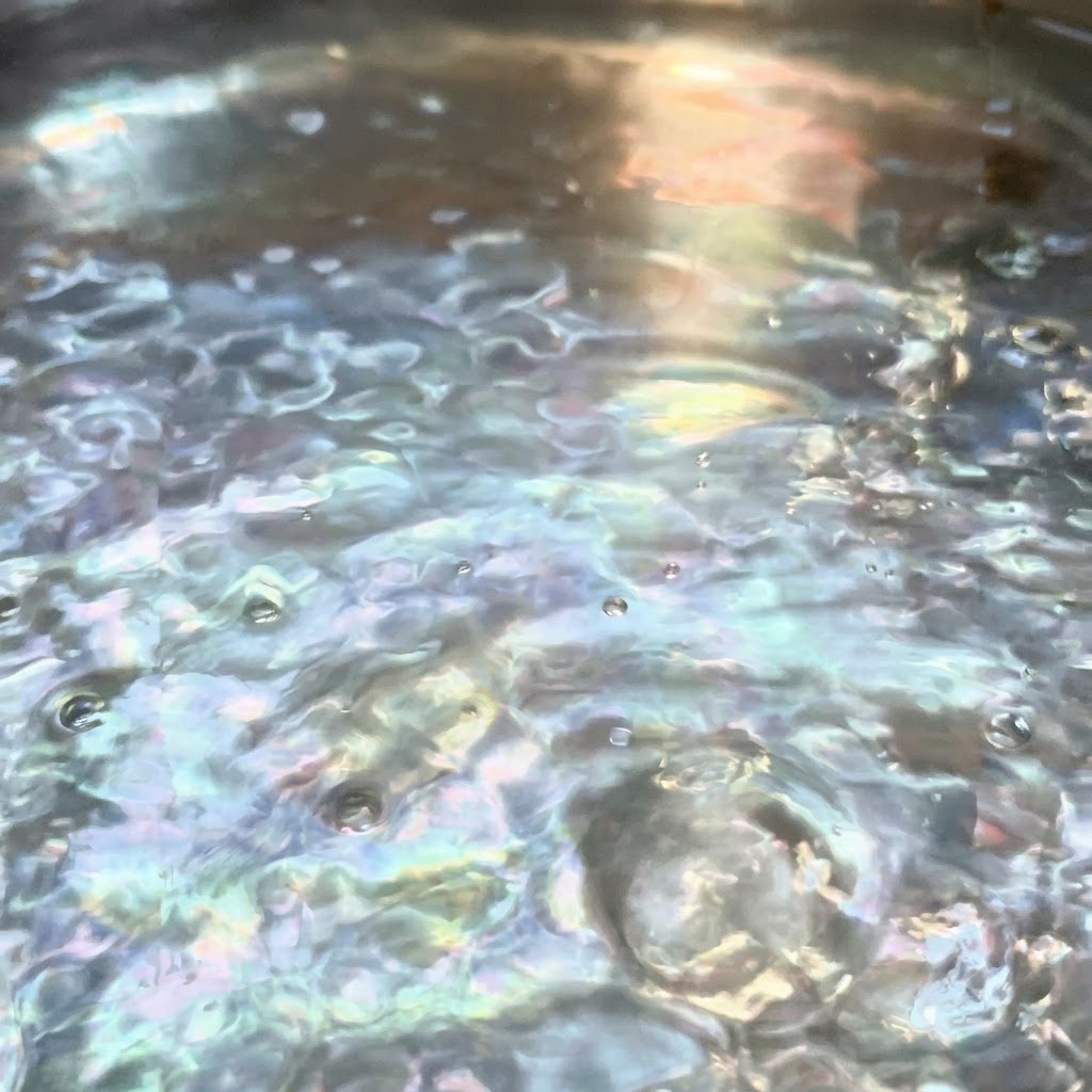 Salt dissolving in a pot of vigorously boiling water.