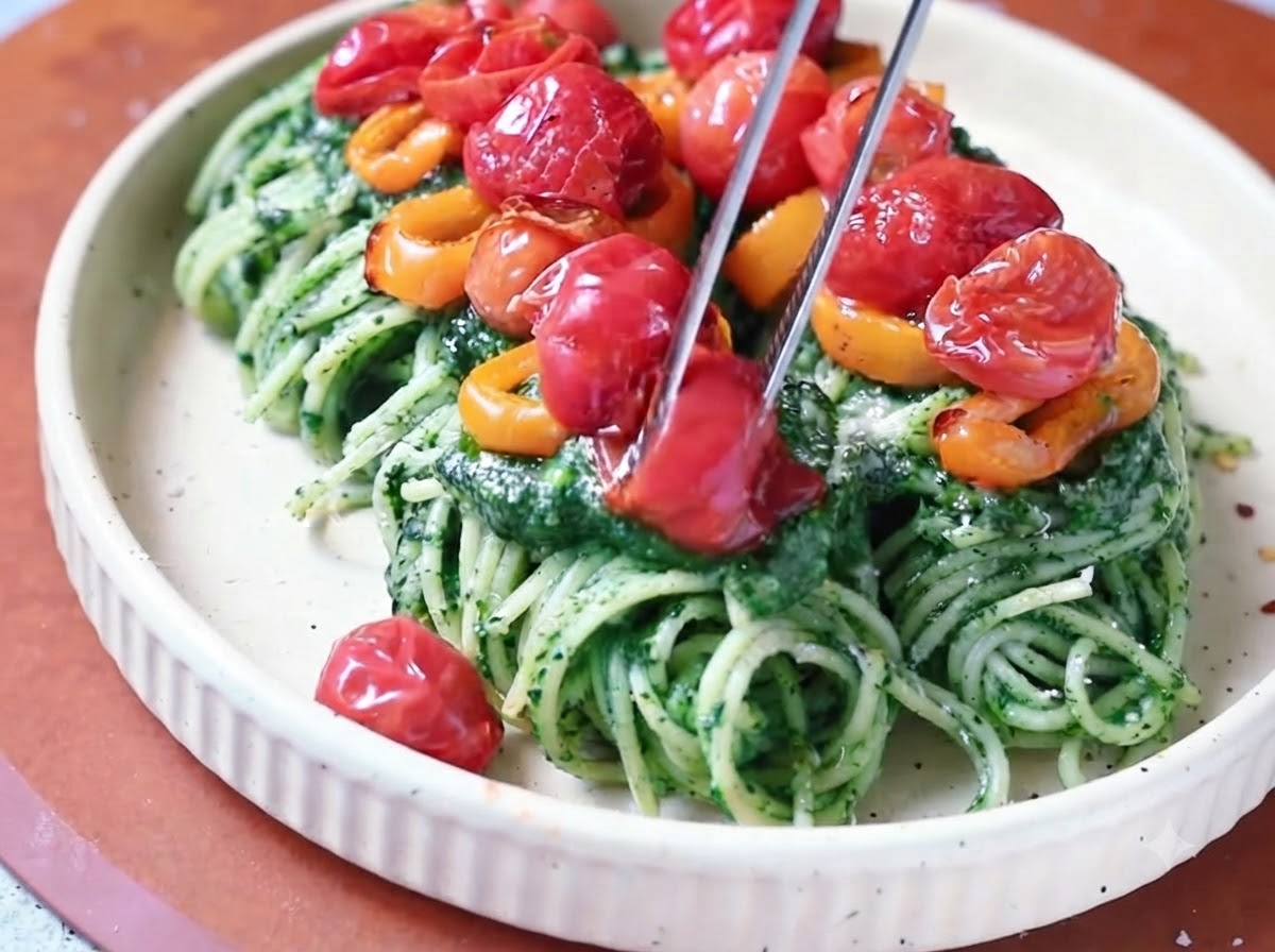 A pat of yellow butter melting into simmering green spinach sauce in a pan.