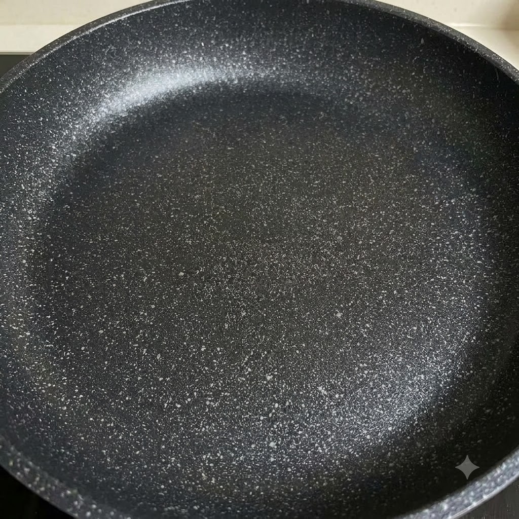 Sliced onions and bell peppers being stir-fried in a pan.