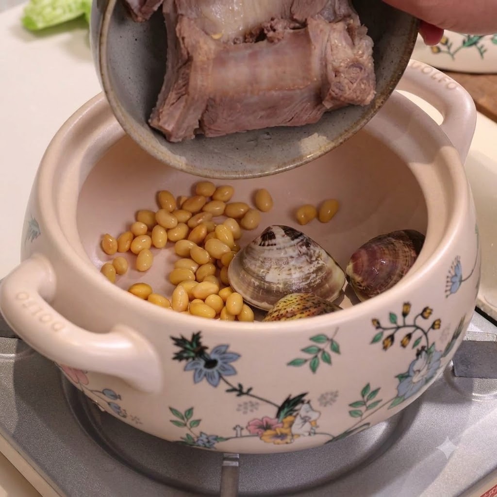 Blanched pork ribs being poured into a ceramic stew pot containing soybeans and clams.