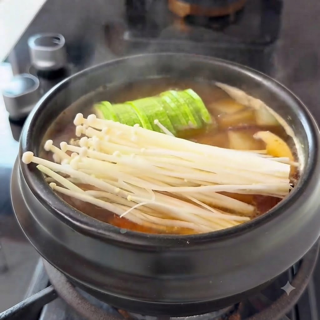 Sliced beef rolls arranged on top of the ingredients inside the cooking pot.