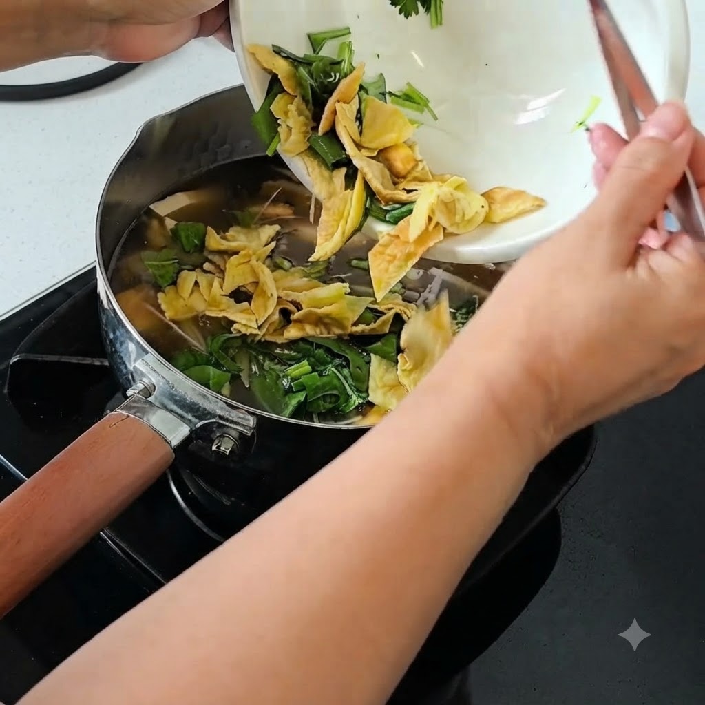 Shredded scallions, cilantro, and chopped century egg being tipped from a white bowl into a simmering pot of soup.