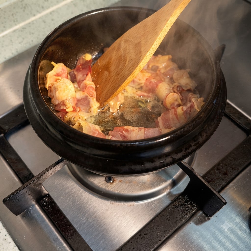 Soy sauce being drizzled over sizzling beef slices inside a hot pot, creating steam.