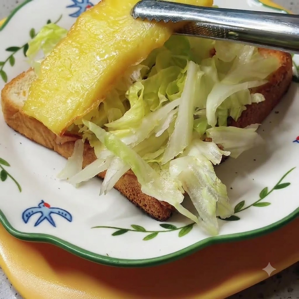 Grilled pineapple slices being arranged on top of the lettuce layer on the sandwich.