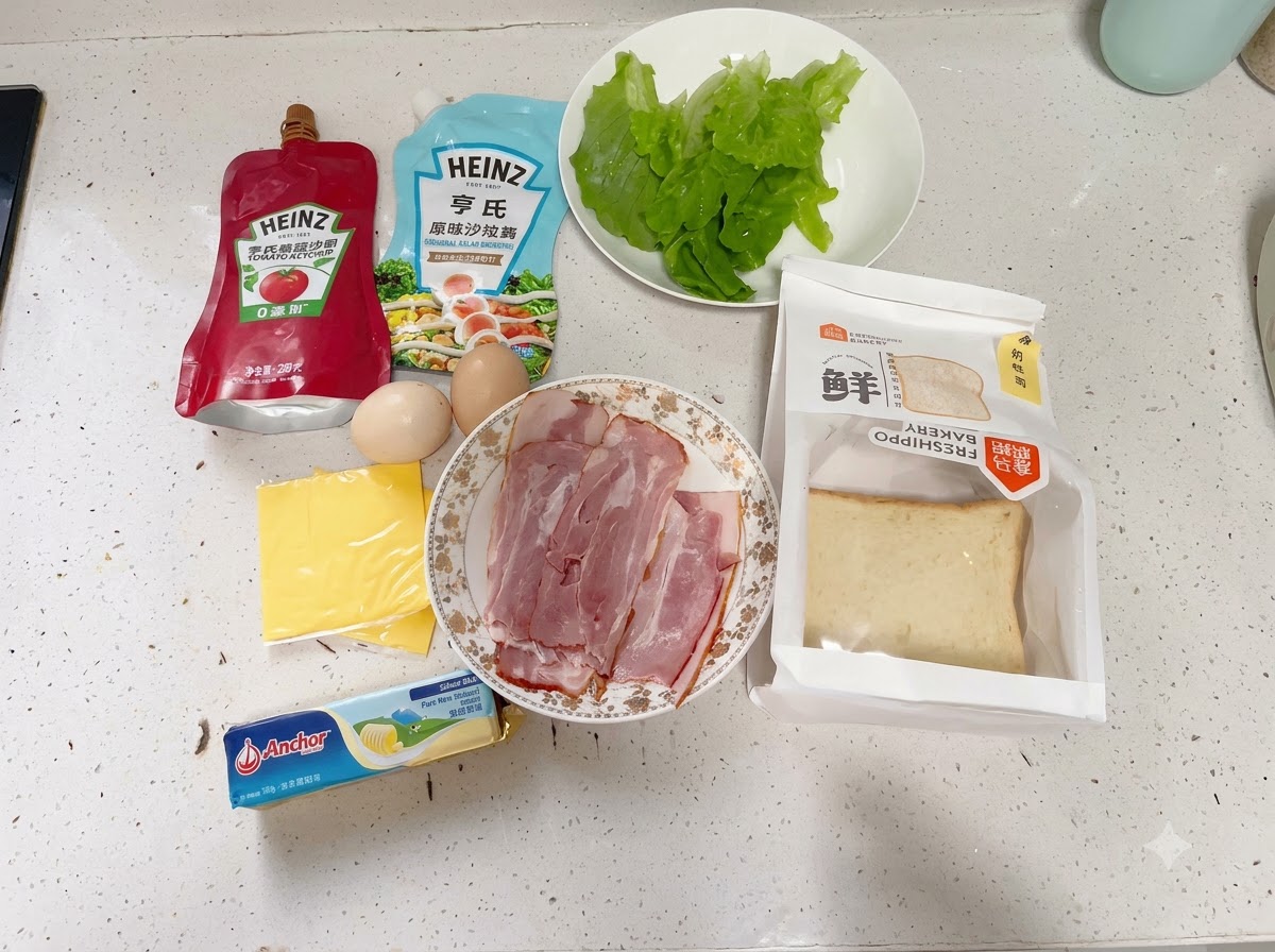 An assortment of sandwich ingredients laid out neatly on a white kitchen countertop.