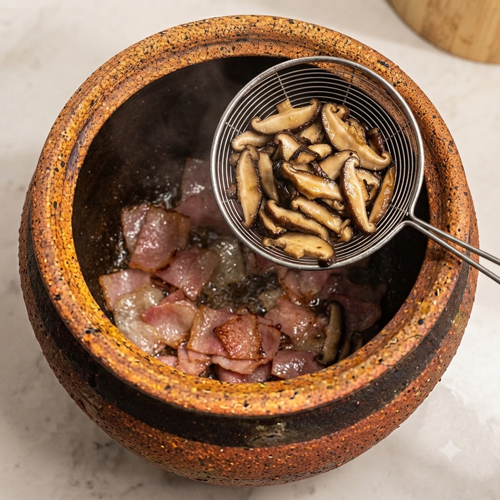 Sliced shiitake mushrooms being added using a strainer into the pot to stir-fry with bacon.