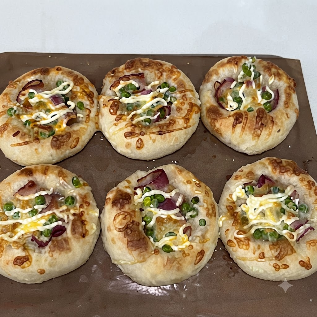 Green peas being sprinkled on top of the bacon layer inside the dough wells.