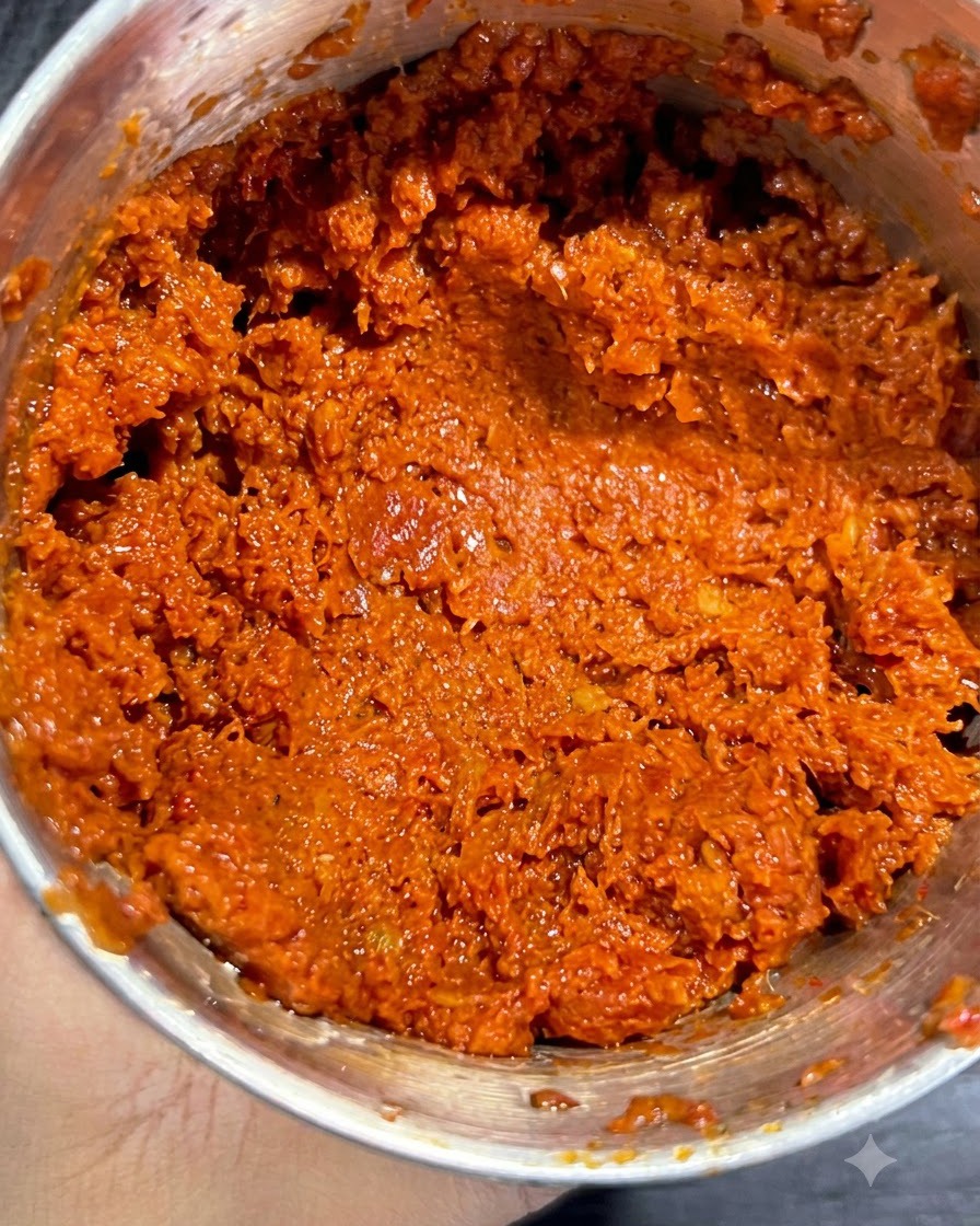 Spaghetti strands being lowered into a pot of bubbling boiling water.