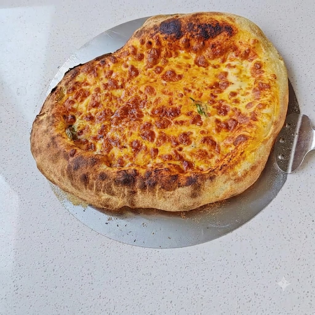Shredded mozzarella cheese being sprinkled over the tomato sauce layer on a pizza dough.
