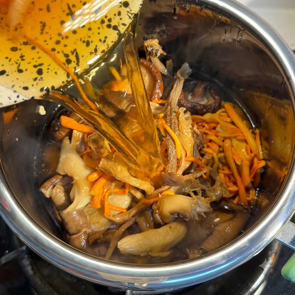 Mushroom soaking water being poured into the pot filled with ingredients.