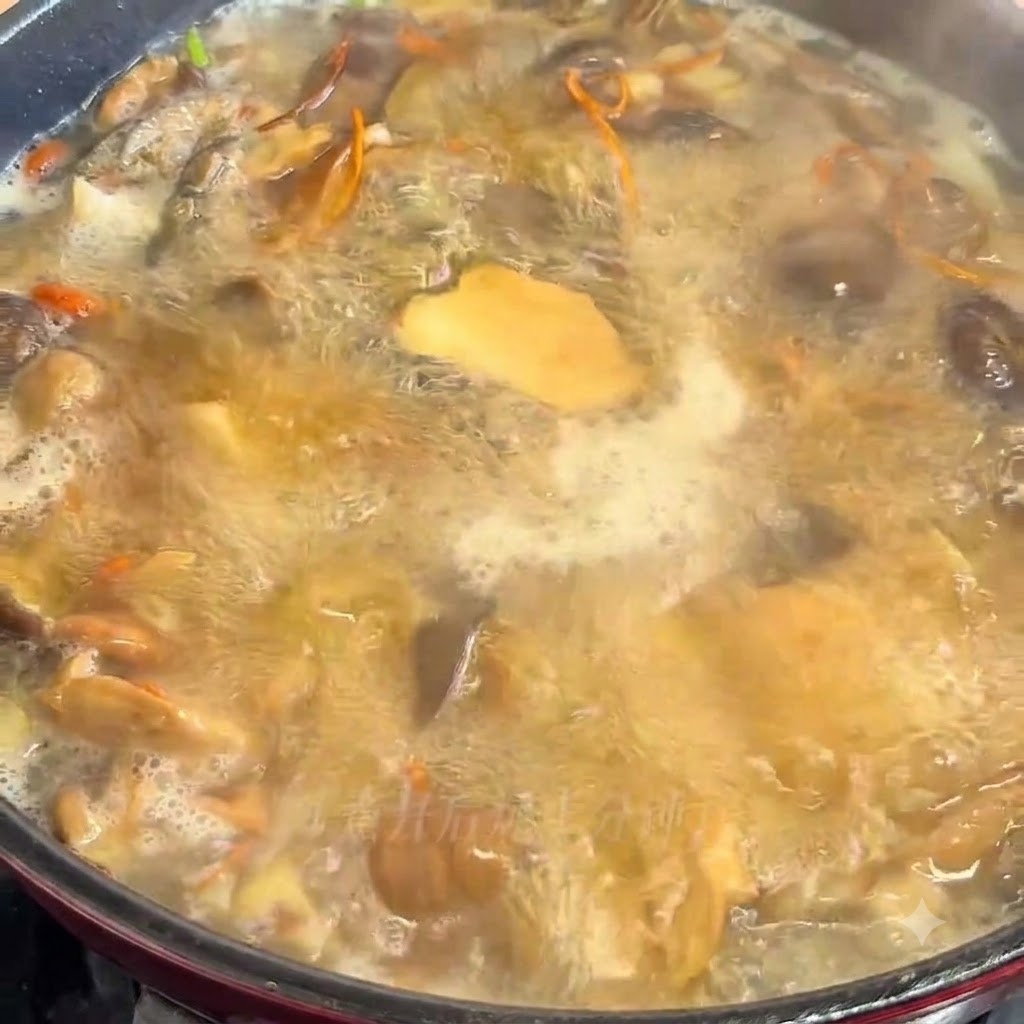 The mushroom soup mixture is actively simmering and boiling in a cooking pot.