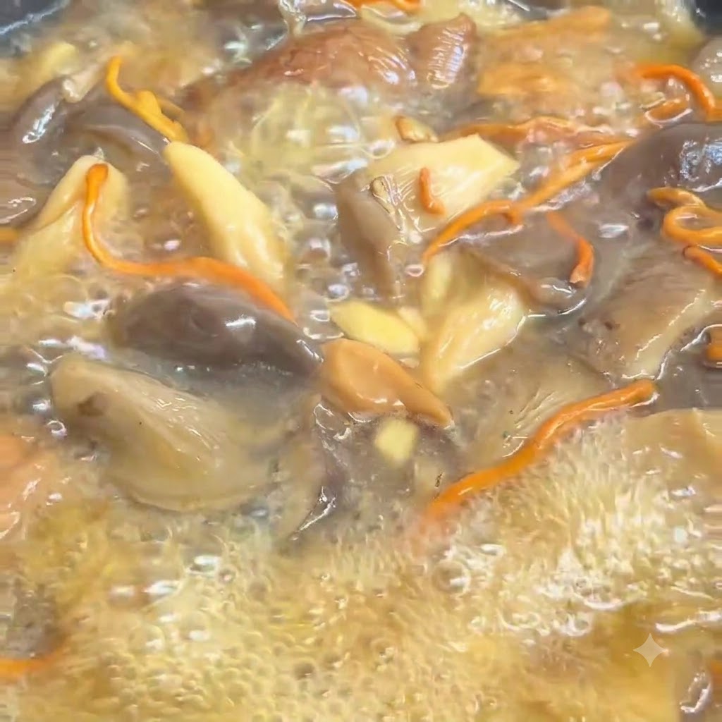 Cooked noodles being rinsed under running water inside a strainer.