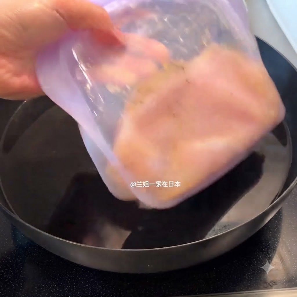 A sealed purple container holding marinated chicken being placed into a pot filled with water.