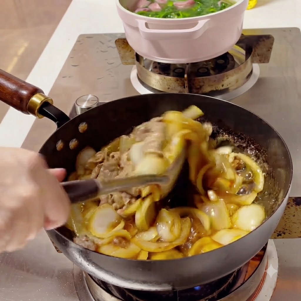 Beef and onions being tossed together in a wok with a rich, thick sauce.