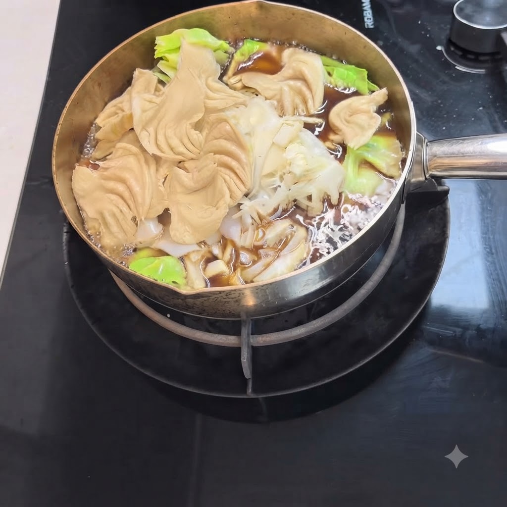 Udon noodles and fresh leafy greens simmering in a pot of dark sukiyaki broth.