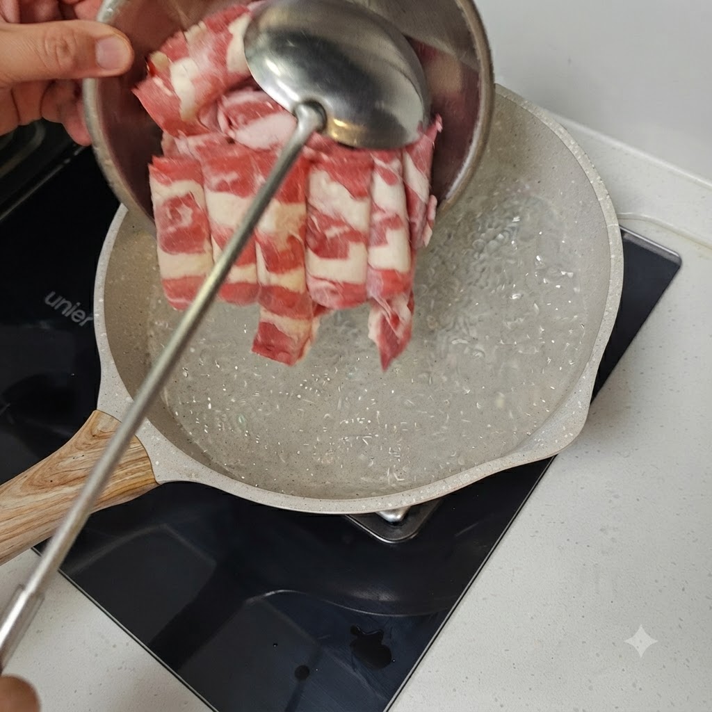 Thinly sliced beef being added into a pan of bubbling boiling water with a metal ladle.
