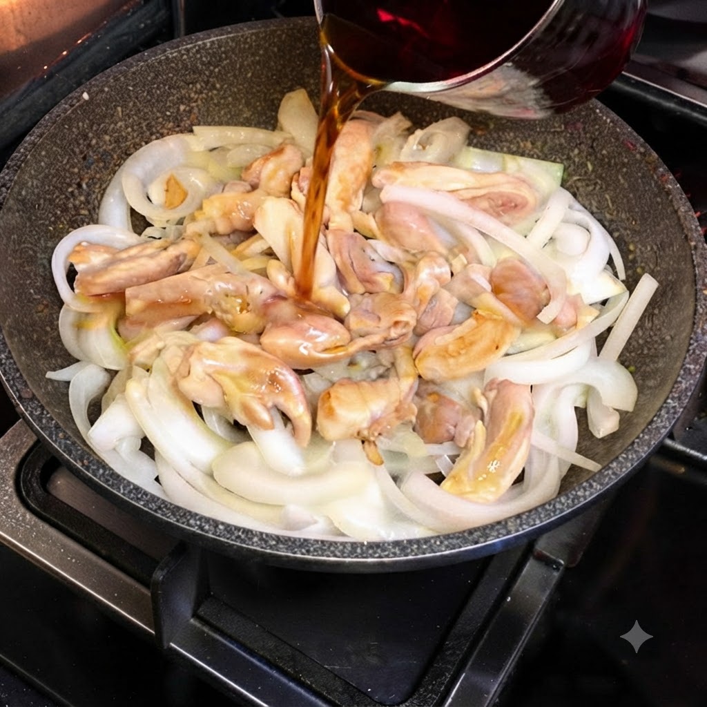Dark sukiyaki sauce being poured from a glass container into a skillet containing chicken pieces and sliced onions.