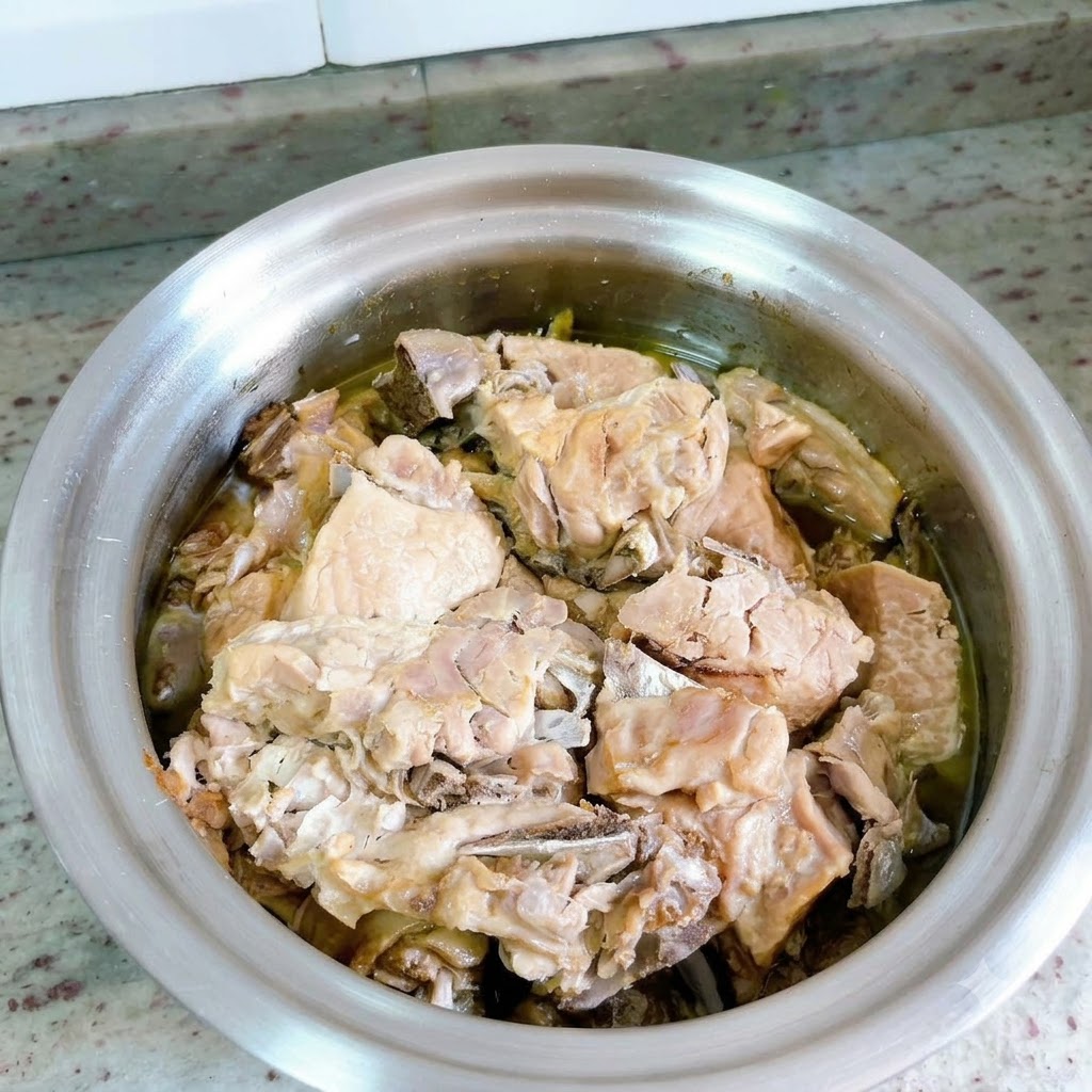 The pressure cooker lid is removed, displaying the cooked duck meat submerged in rich broth.