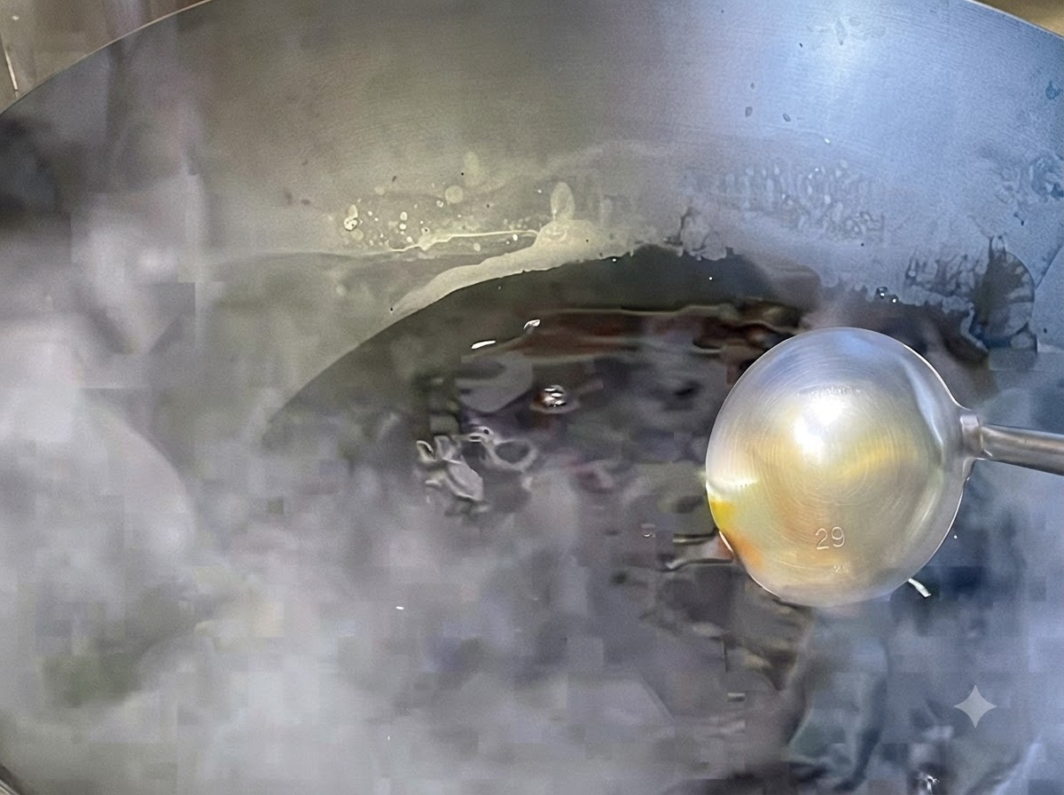 Sauce simmering and reducing on low heat in a wok.