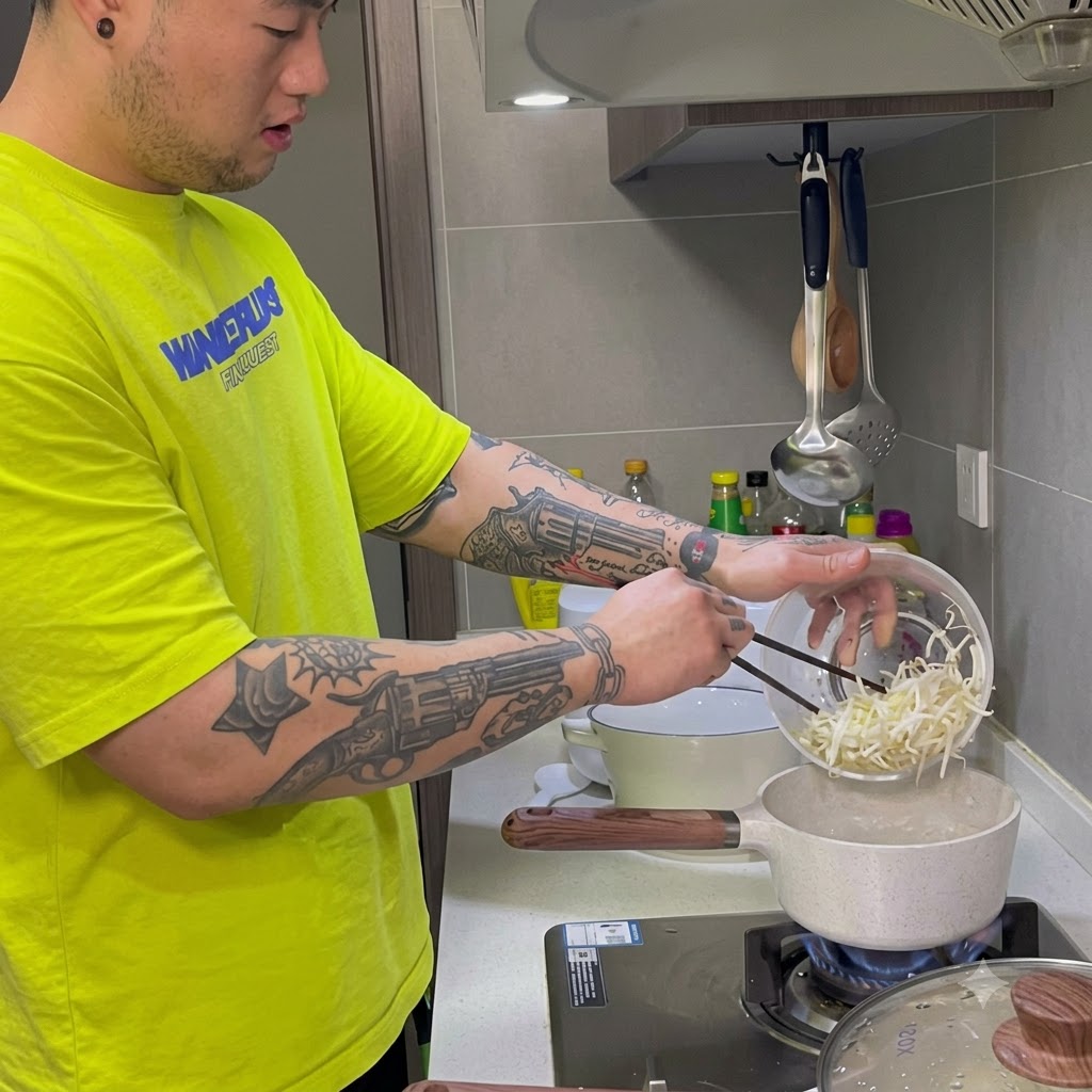 Bean sprouts and shredded carrots being boiled in a pot on the stove.