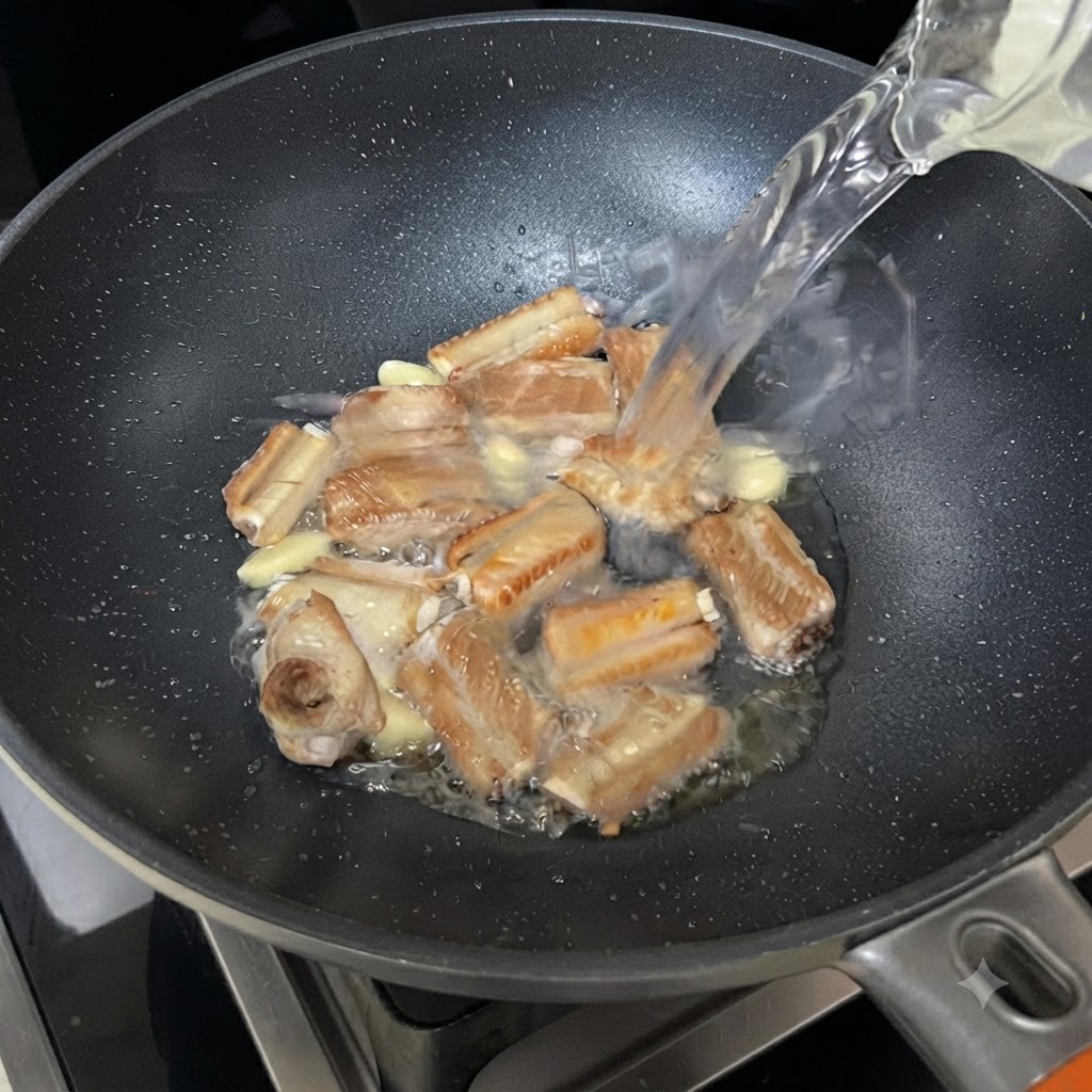 Water streaming from a bowl into the sizzling pan of ribs and garlic.