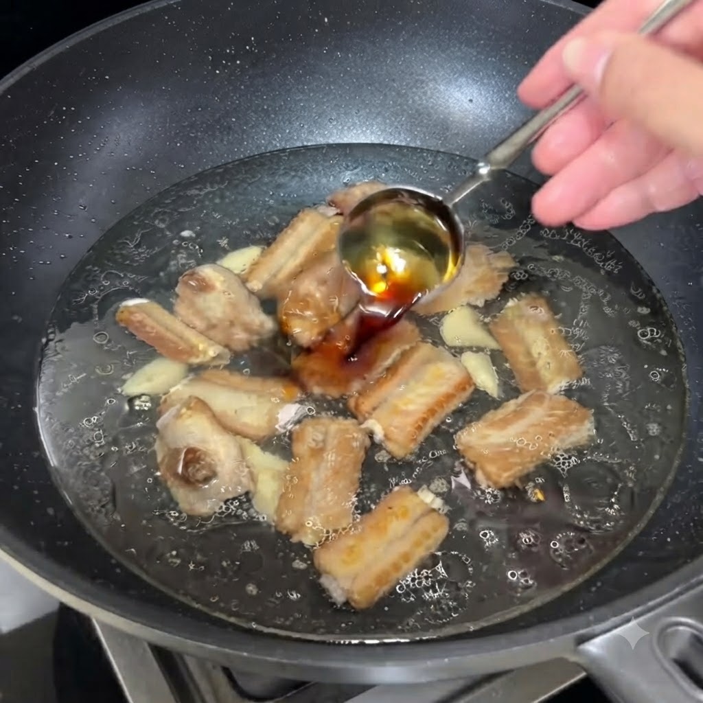 A spoonful of light soy sauce being poured into the bubbling broth with ribs.