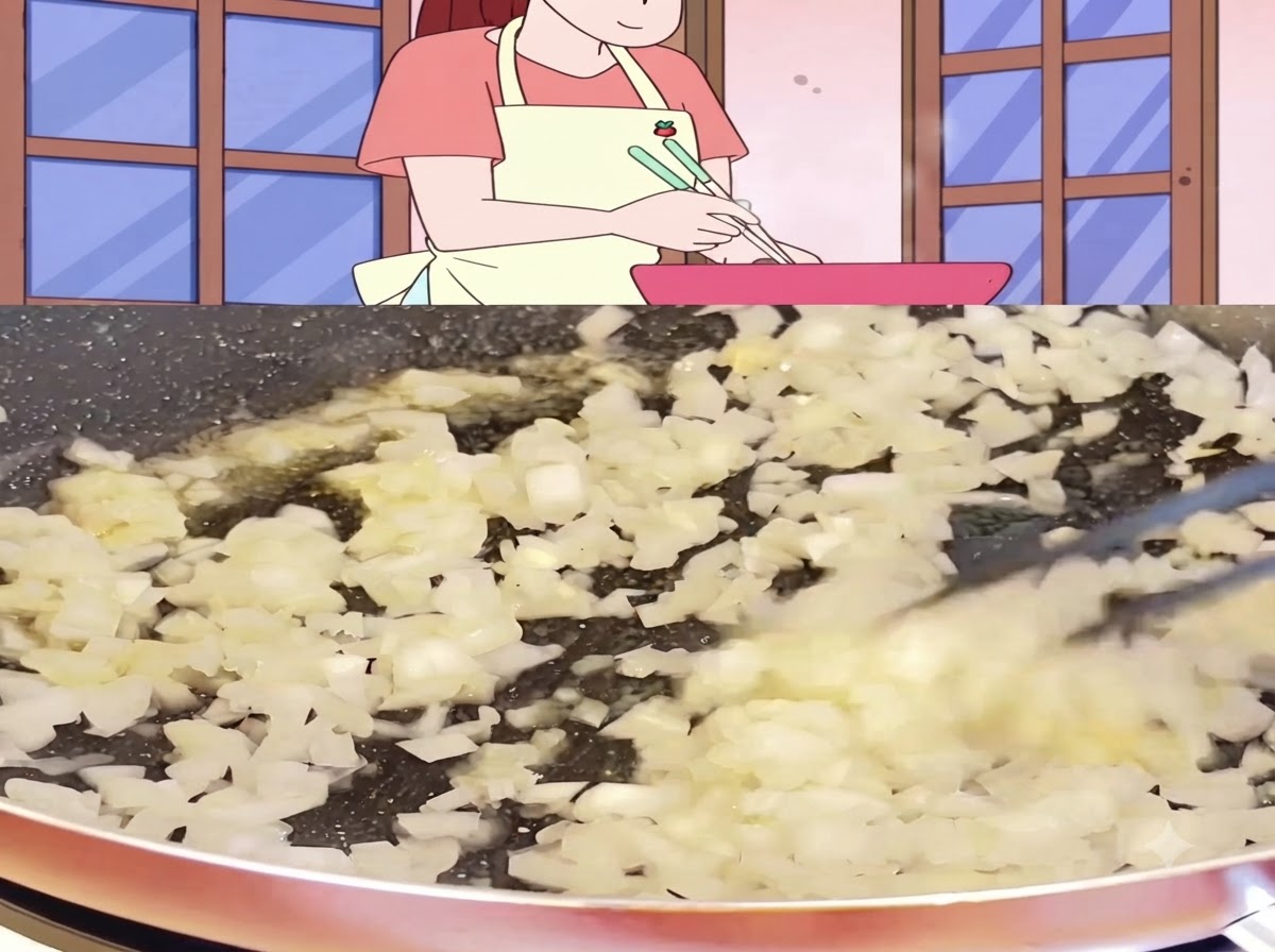 Diced onions cooking and sizzling in a pan until soft and lightly translucent.