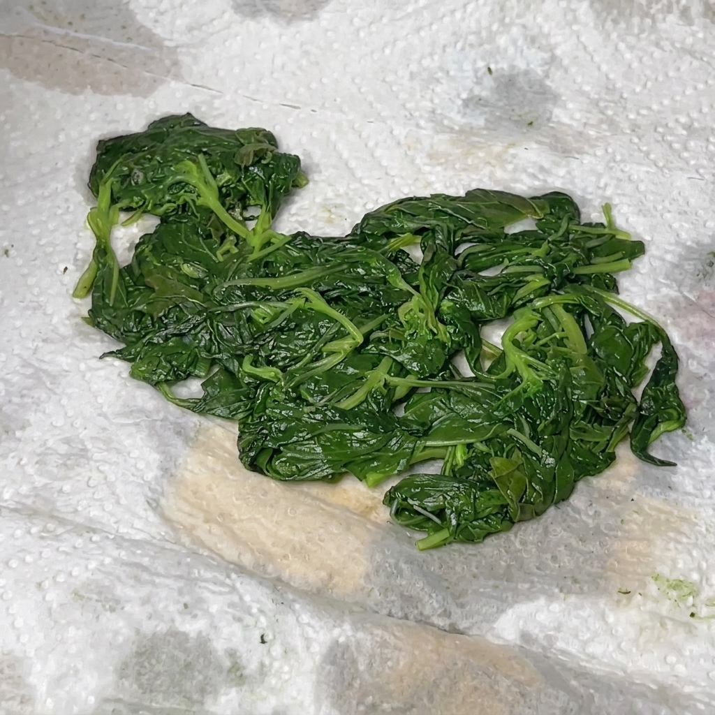 Basil, parmesan, pine nuts, and olive oil combined inside a food processor.